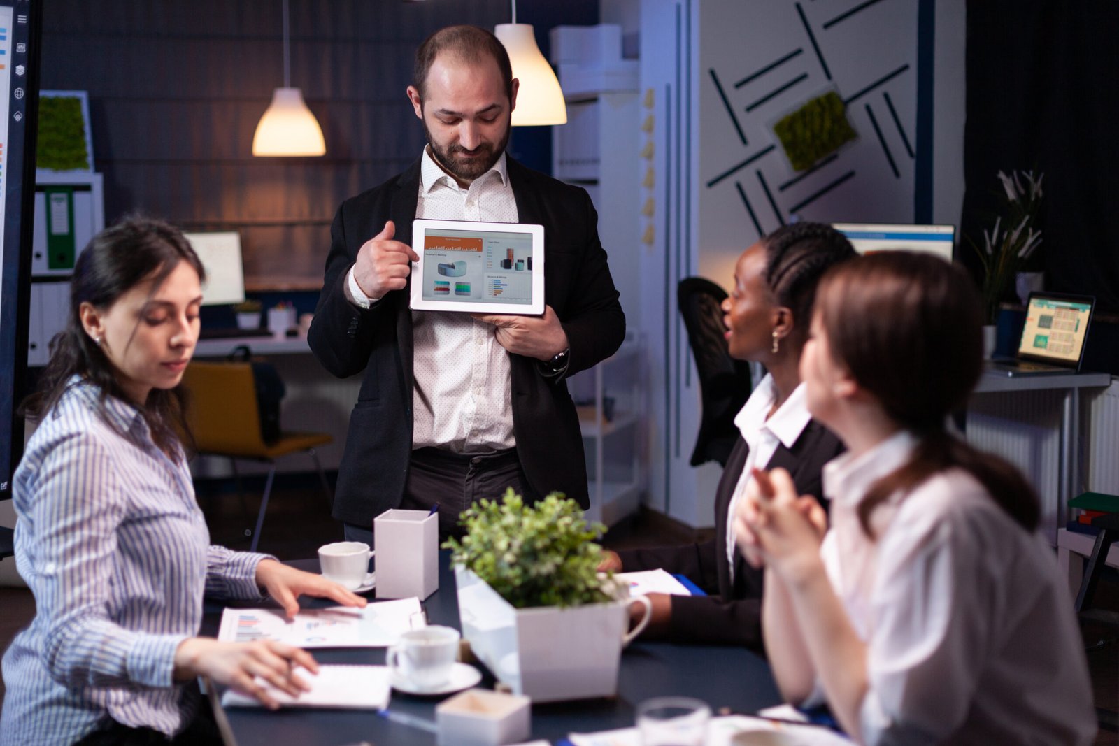 Professional reviewing business charts on a tablet